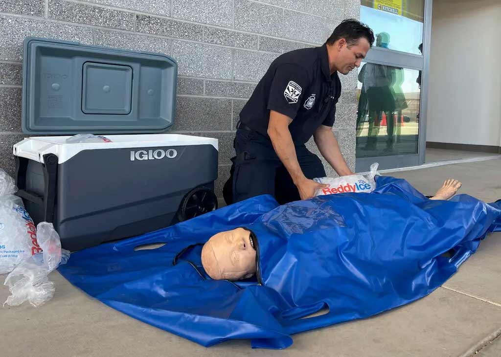 EMS worker demonstrating an ice immersion bag
