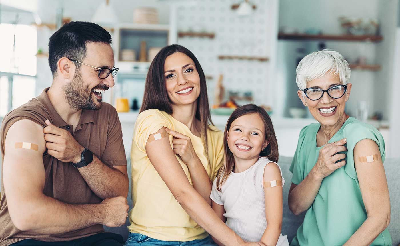 Family members showing COVID-19 vaccine bandages